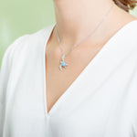 The picture shows a model wearing a 925 sterling silver larimar sea turtle pendant.