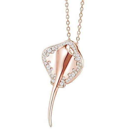 The picture shows a rose gold manta ray pendant with topaz.