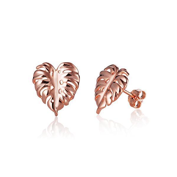 In this photo there is a pair of 14k rose gold monstera stud earrings.