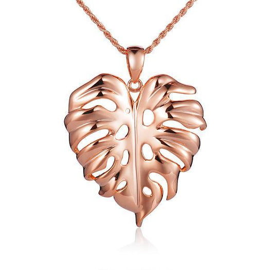 In this photo there is a rose gold monstera pendant.