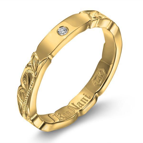 The picture shows a 14K yellow gold diamond 3mm ring with hand engravings including a diamond.
