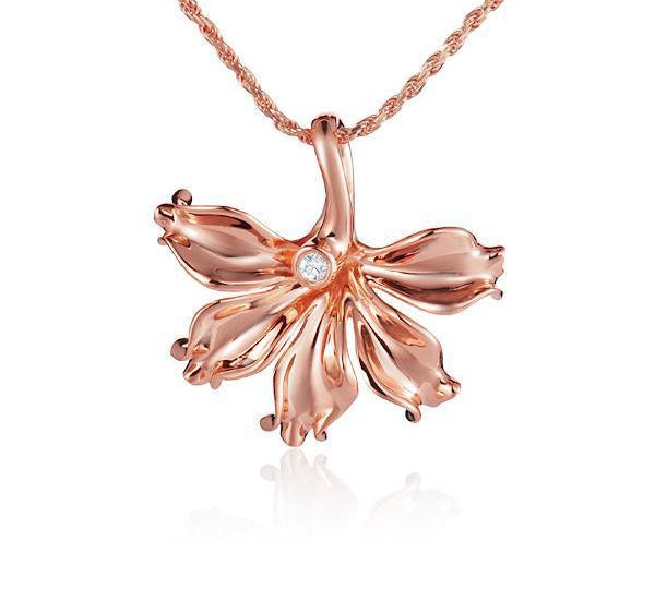 In this photo there is a rose gold naupaka flower pendant with one diamond.