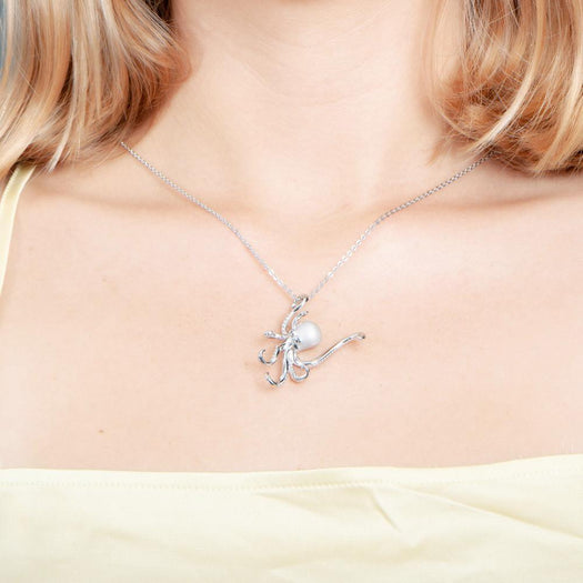 The picture shows a model wearing a 925 sterling silver octopus pendant with topaz.
