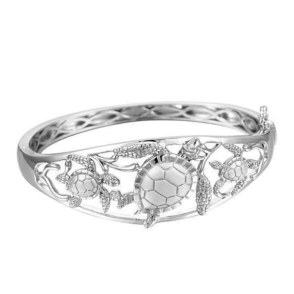 The picture shows a 925 sterling silver three sea turtle bangle with topaz.
