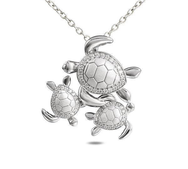 The picture shows a 925 sterling silver three sea turtle pendant with topaz.