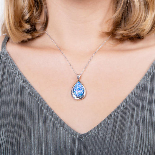 The picture shows a model wearing a 925 sterling silver opalite teardrop pendant.