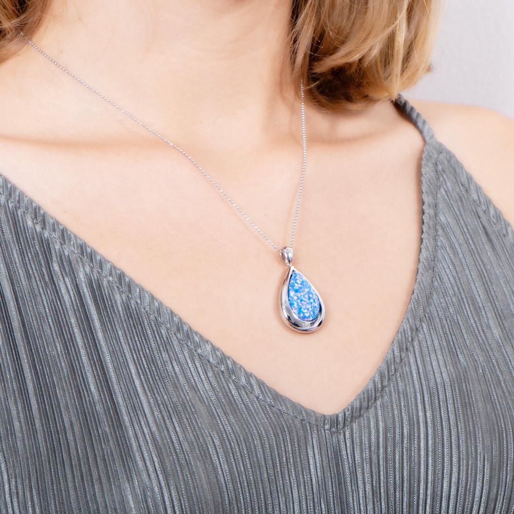 The picture shows a model wearing a 925 sterling silver opalite teardrop pendant.