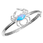 The picture shows a 925 sterling silver blue crab bangle with opalite.