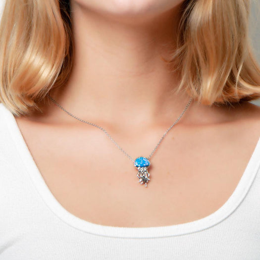 The picture shows a model wearing a 925 sterling silver opalite button jellyfish pendant.