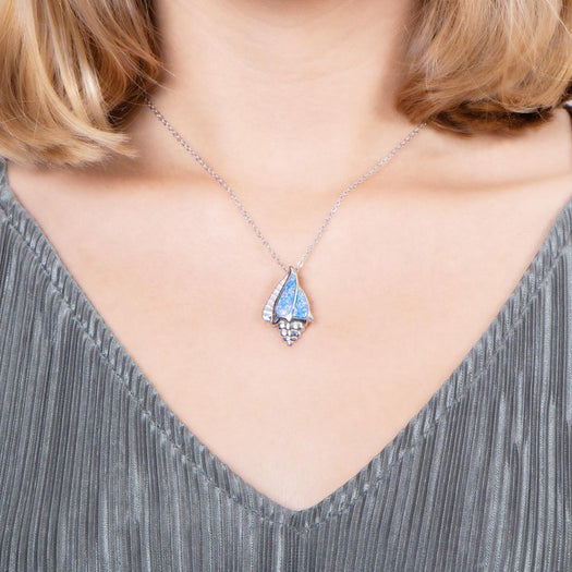 The picture shows a model wearing a 925 sterling silver opalite conch shell pendant.