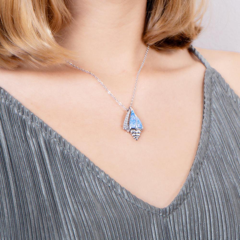 The picture shows a model wearing a 925 sterling silver opalite conch shell pendant.