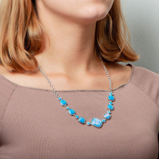 The picture shows a model wearing a 925 sterling silver opalite cushion cut necklace.