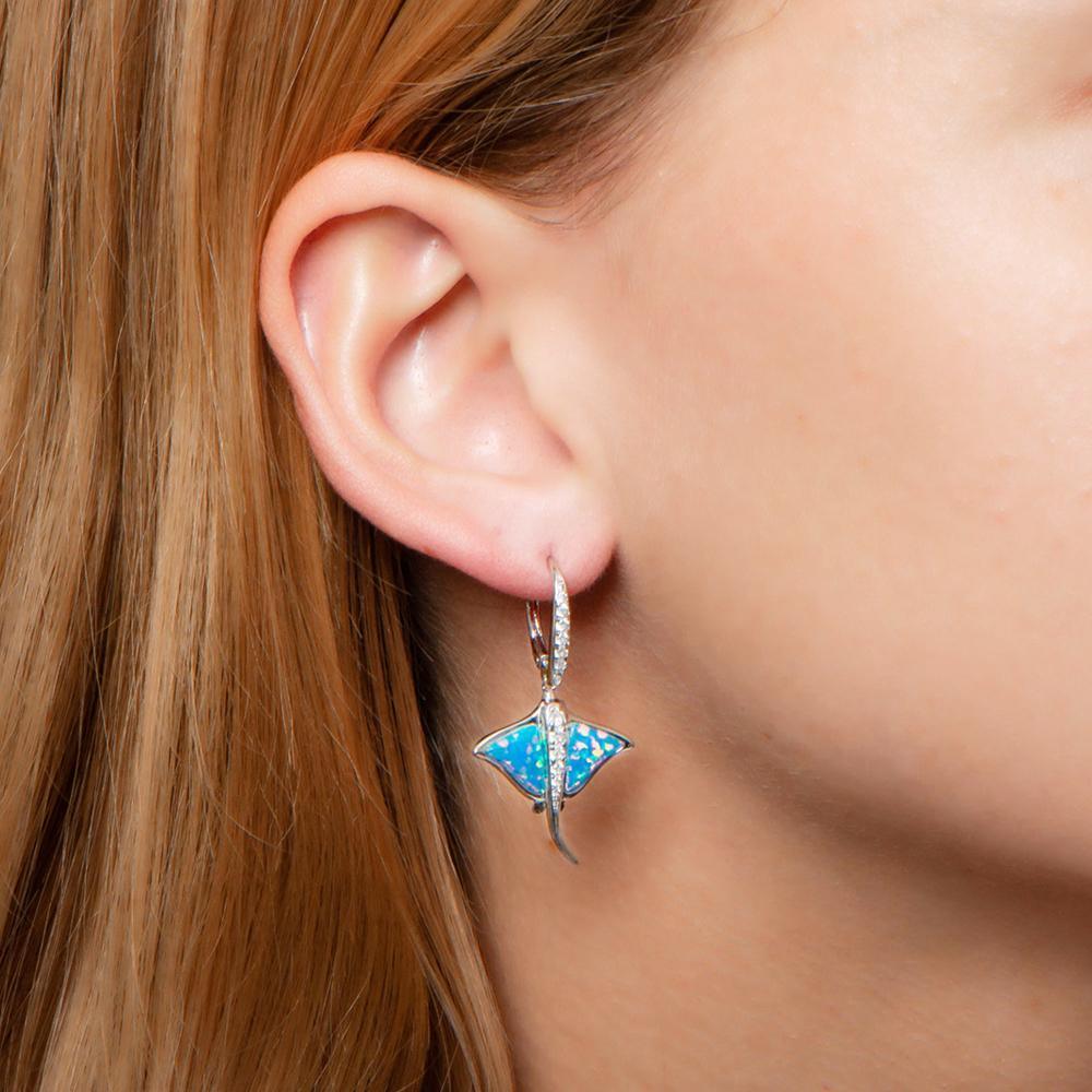 The picture shows a model wearing a 925 sterling silver opalite eagle ray earring with cubic zirconia.