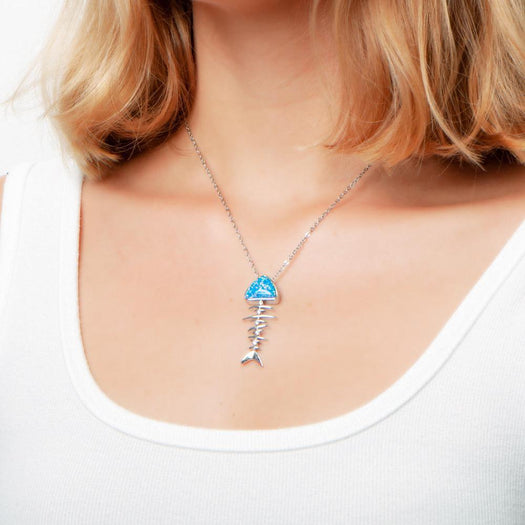 The picture shows a model wearing a 925 sterling silver opalite fish bone pendant.