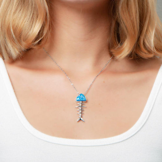 The picture shows a model wearing a 925 sterling silver opalite fish bone pendant.