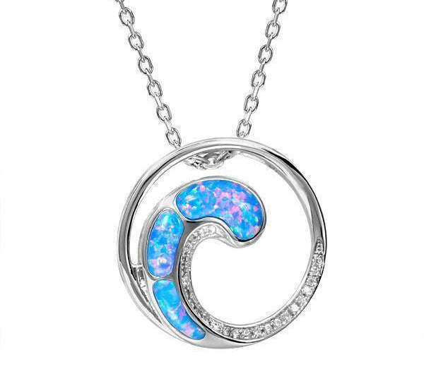 In this photo there is a sterling silver circle and wave pendant with blue opalite and topaz gemstones.