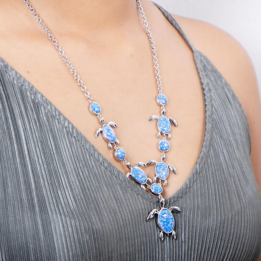The picture shows a model wearing a 925 sterling silver opalite sea turtle charm necklace.