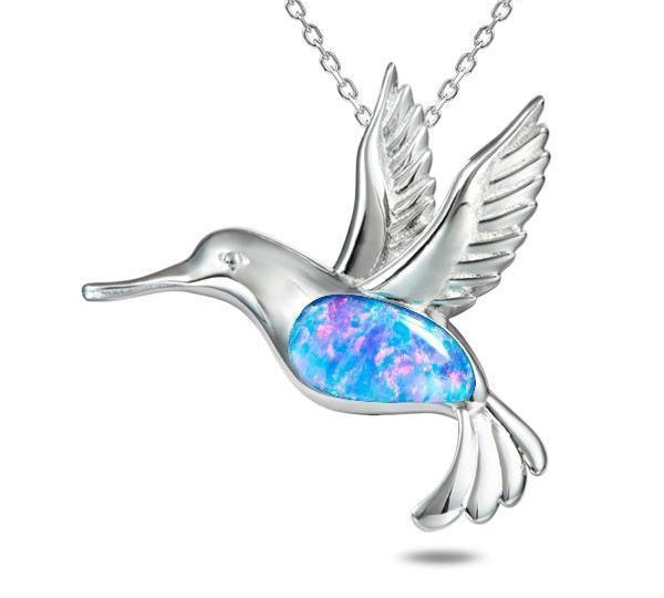 In this photo there is a sterling silver hummingbird pendant with topaz and blue opalite gemstones.