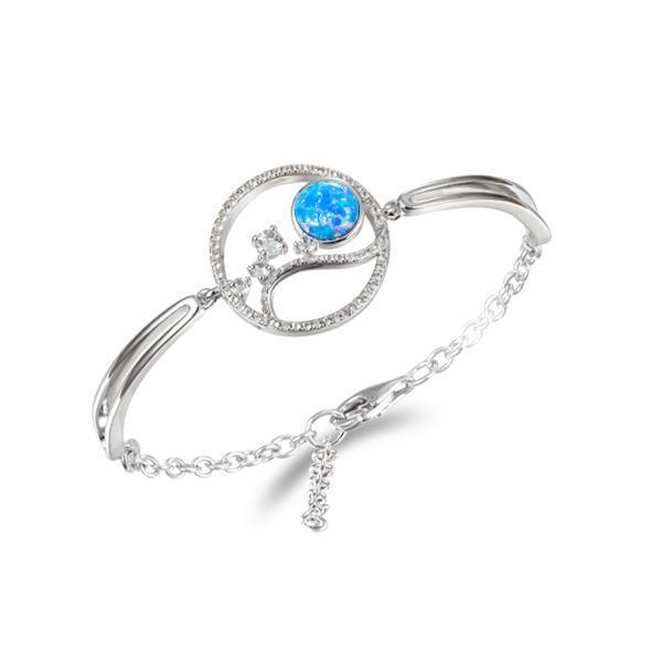 In this photo there is a 925 sterling silver wave and sun bracelet with blue opalite, aquamarine and topaz gemstones.
