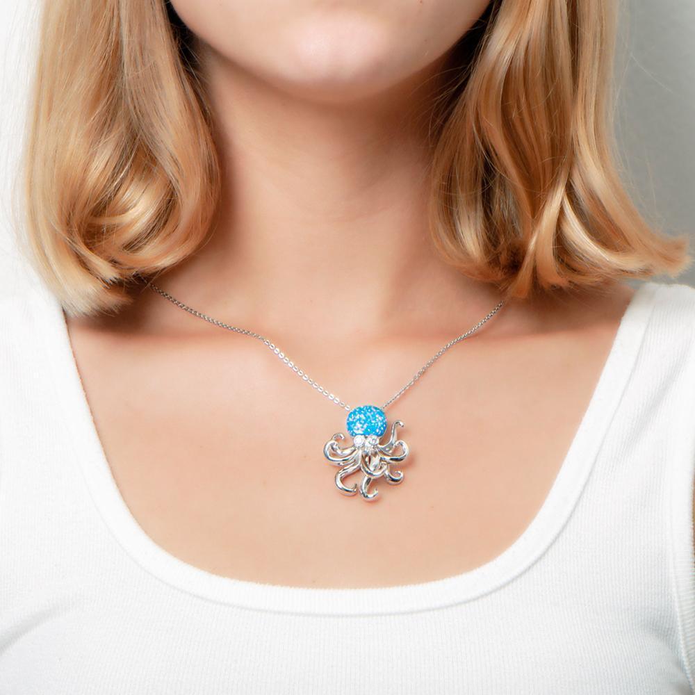 The picture shows a model wearing a 925 sterling silver opalite octopus pendant with topaz.