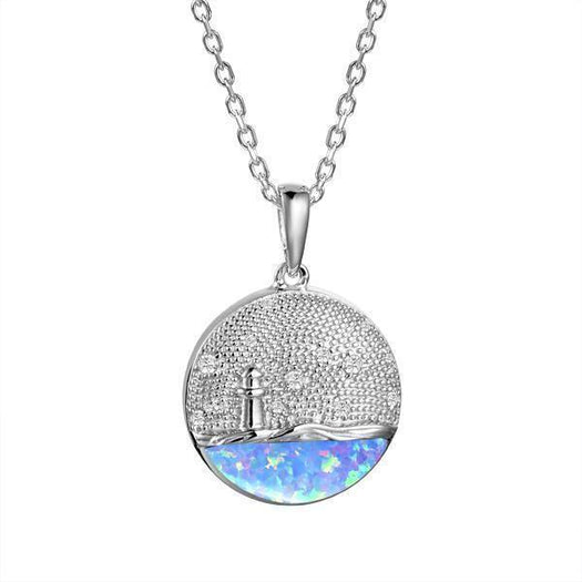 In this photo there is a sterling silver lighthouse medallion pendant with blue opalite and topaz gemstones.