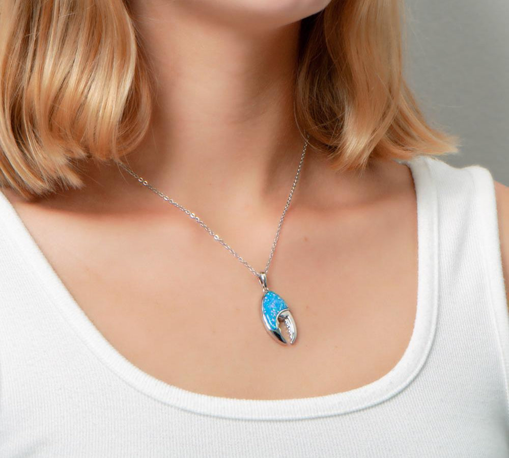 The picture shows a model wearing a 925 sterling silver opalite lobster claw pendant.