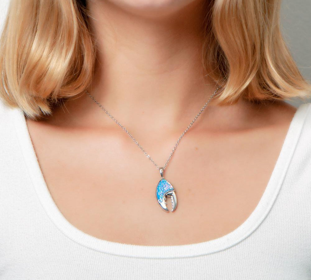 The picture shows a model wearing a 925 sterling silver opalite lobster claw pendant.