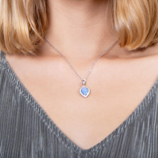 The picture shows a model wearing a 925 sterling silver opalite mandorla pendant with cubic zirconia.