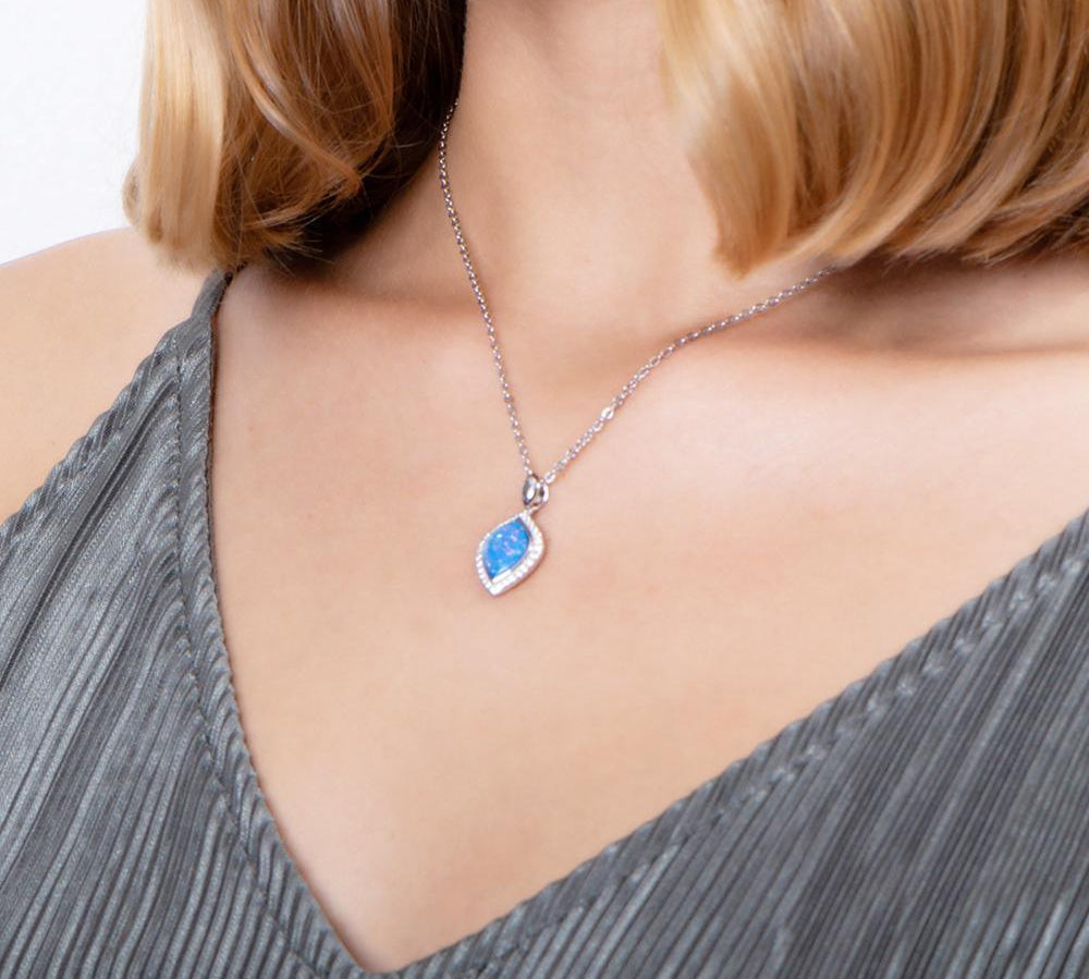 The picture shows a model wearing a 925 sterling silver opalite mandorla pendant with cubic zirconia.