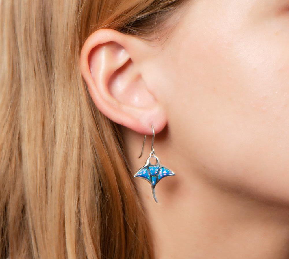 The picture shows a model wearing a 925 sterling silver opalite manta ray hook earring.