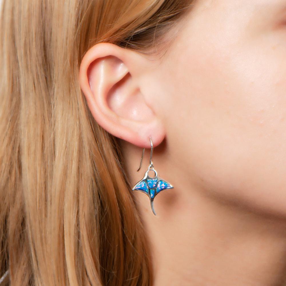 The picture shows a model wearing a 925 sterling silver opalite manta ray hook earring.