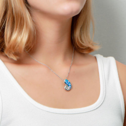 The picture shows a model wearing a 925 sterling silver opalite nautilus pendant.