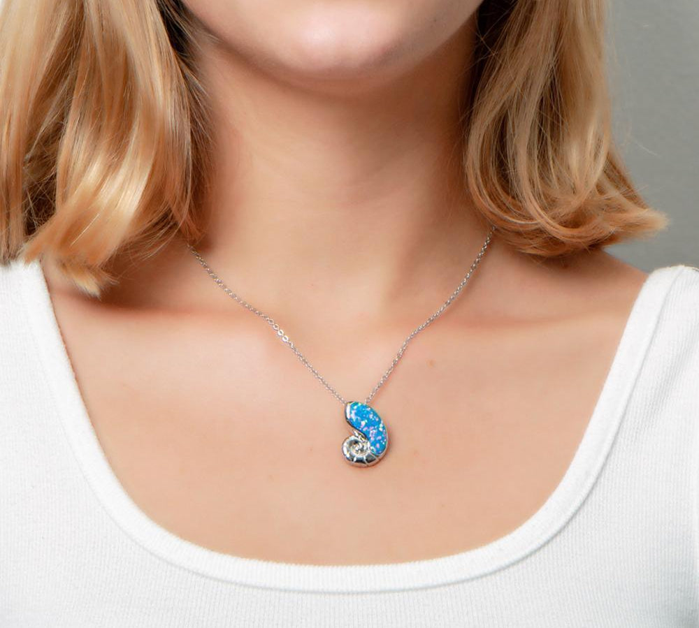 The picture shows a model wearing a 925 sterling silver opalite nautilus pendant.