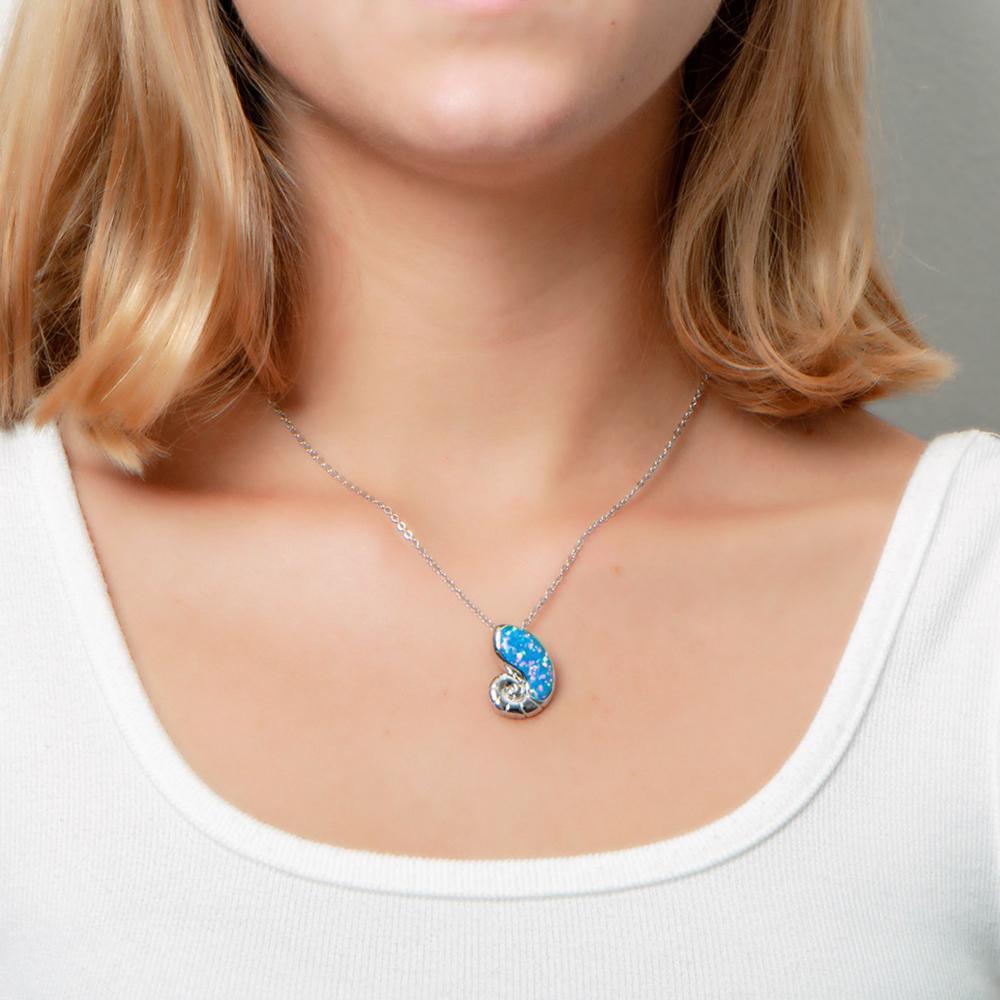 The picture shows a model wearing a 925 sterling silver opalite nautilus pendant.