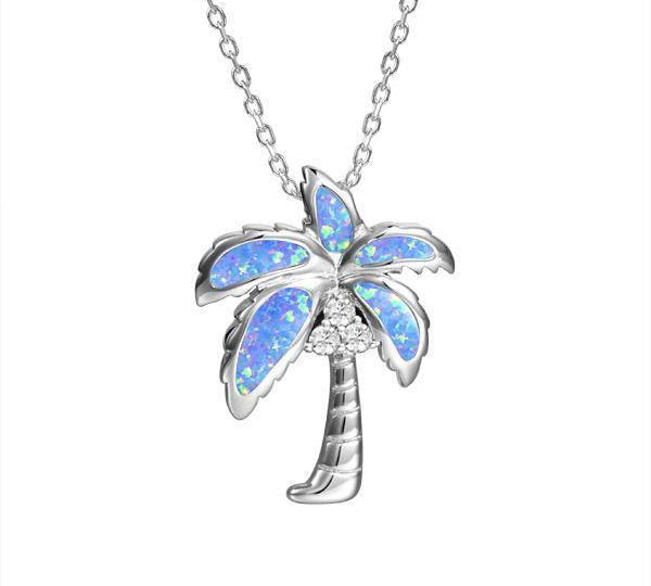 In this photo there is a sterling silver palm tree pendant with blue opalite and three topaz gemstones.