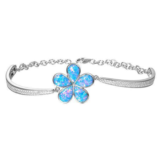 In this photo there is a sterling silver plumeria bracelet with blue opalite gemstones and cubic zirconia.