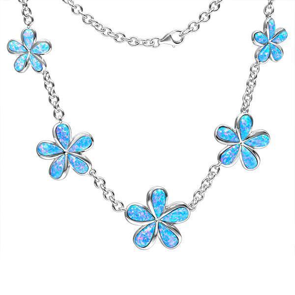 In this photo there is a sterling silver charm necklace with five plumeria flowers and blue opalite gemstones.