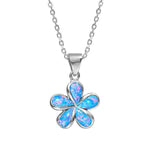 In this photo there is a small sterling silver plumeria pendant with blue opalite gemstones.