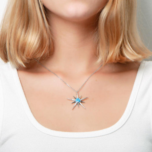 The picture shows a model wearing a 925 sterling silver opalite shooting star pendant and topaz.