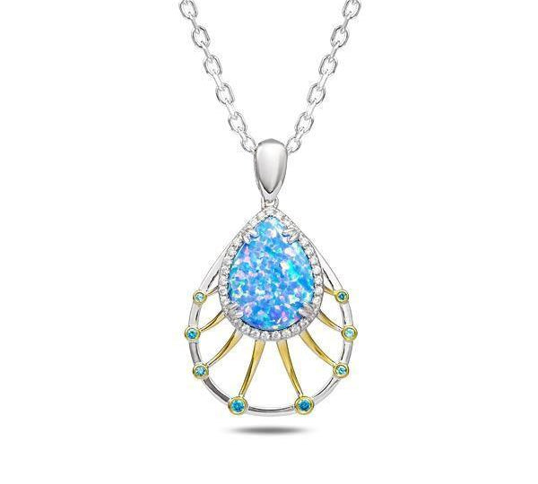 In this photo there is a sterling silver and gold plated teardrop pendant with blue opalite, aquamarine, and topaz gemstones.