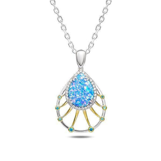 In this photo there is a sterling silver and gold plated teardrop pendant with blue opalite, aquamarine, and topaz gemstones.