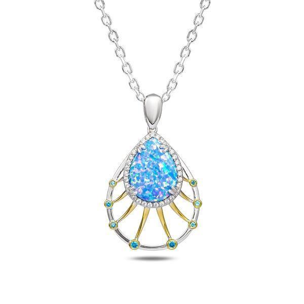 In this photo there is a sterling silver and gold plated teardrop pendant with blue opalite, aquamarine, and topaz gemstones.