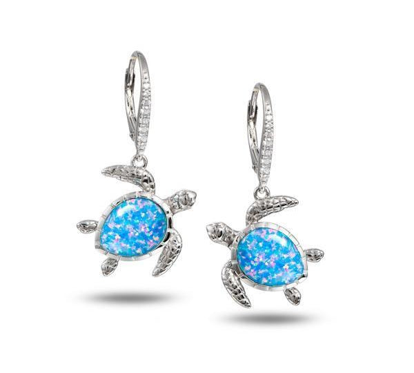 The picture shows a pair of 925 sterling silver opalite swimming sea turtle earrings with cubic zirconia.