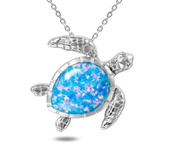 The picture shows a 925 sterling silver opalite swimming sea turtle pendant and topaz.