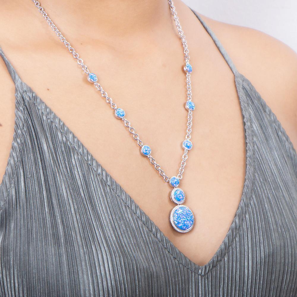 The picture shows a model wearing a 925 sterling silver opalite three circles necklace and topaz.
