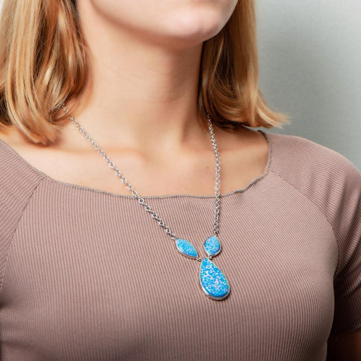 The picture shows a model wearing a 925 sterling silver opalite three drop necklace.