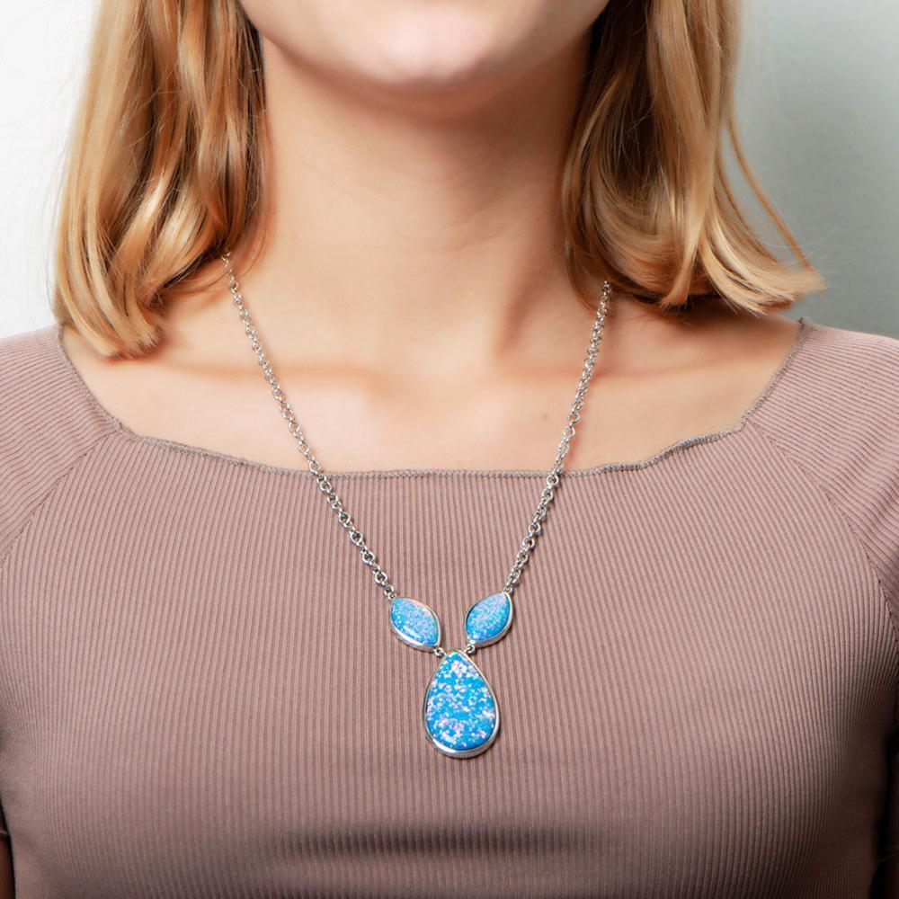 The picture shows a model wearing a 925 sterling silver opalite three drop necklace.