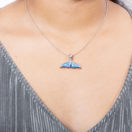The picture shows a model wearing a 925 sterling silver opalite whale tail pendant.