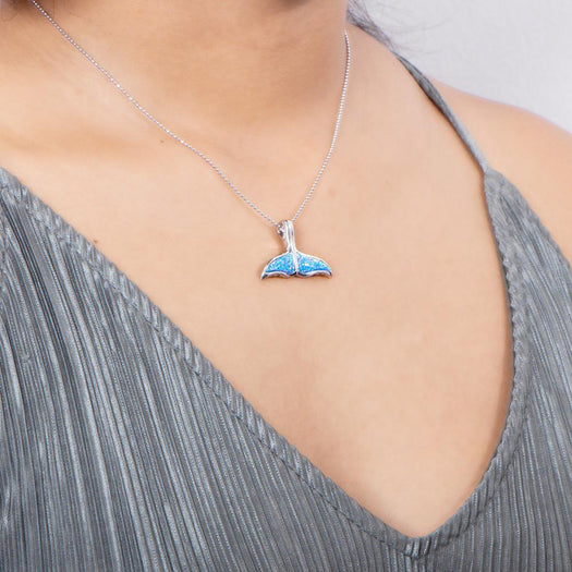 The picture shows a model wearing a 925 sterling silver opalite whale tail pendant.