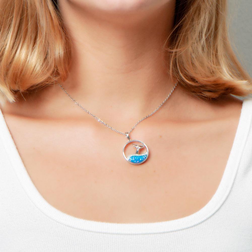 The picture shows a model wearing a 925 sterling silver opalite whale tail wave pendant with topaz.